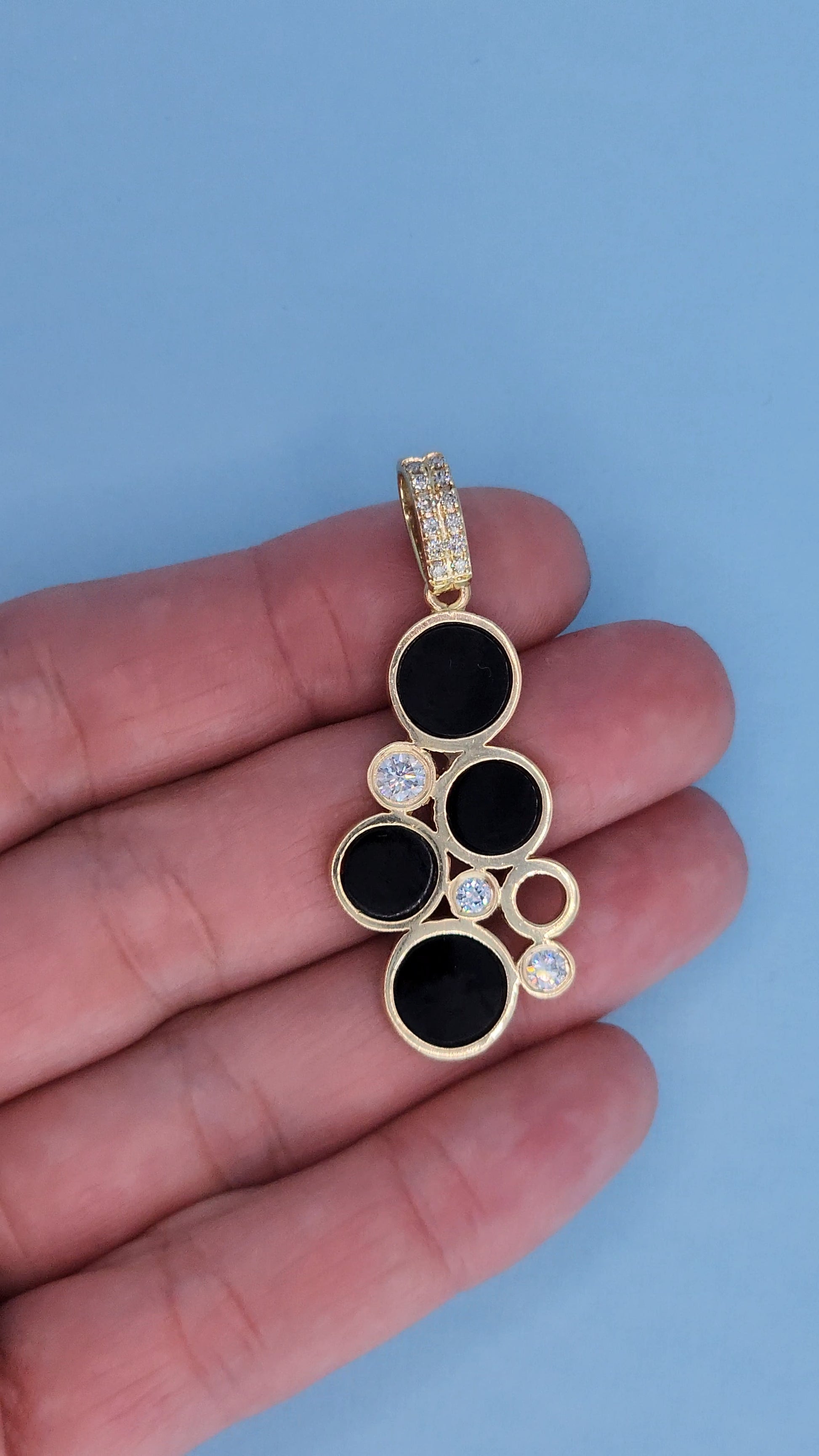 14k Yellow Gold Bubble Pendant with Black Onyx and Diamond Accents Front on the Hand