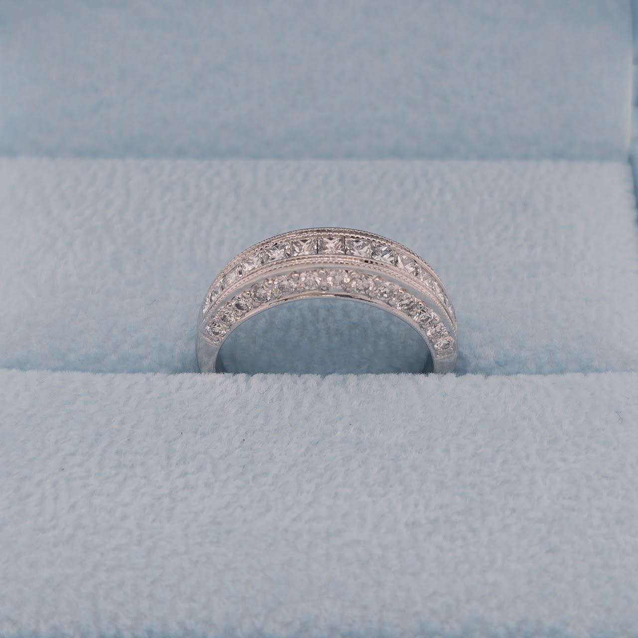 18k white gold three-sided diamond wedding band in blue box