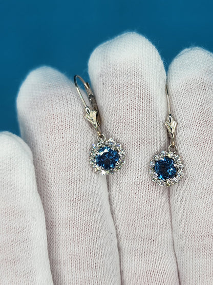 Blue Topaz and Halo Diamonds Dangling Earrings in 14k White Gold