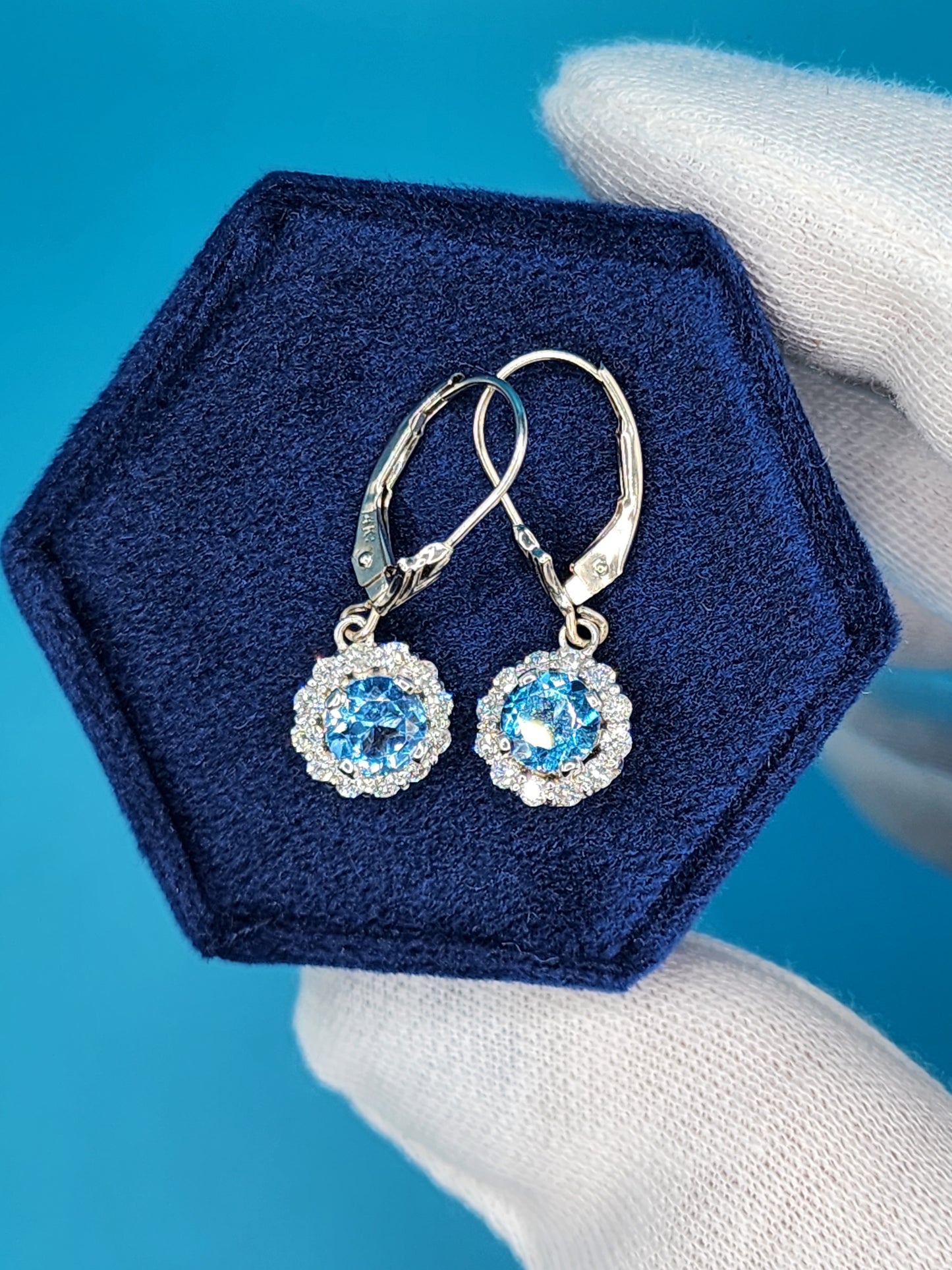 Blue Topaz and Halo Diamonds Dangling Earrings in 14k White Gold