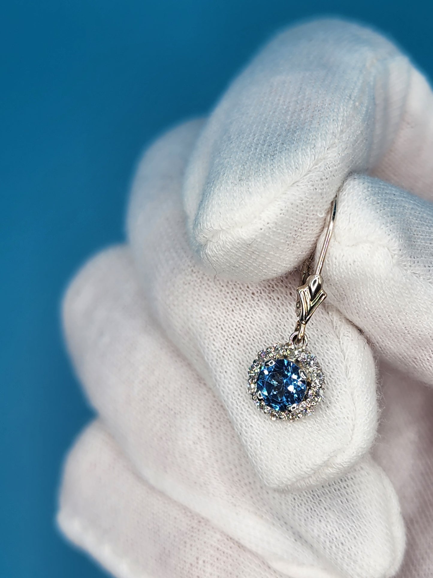 Blue Topaz and Halo Diamonds Dangling Earrings in 14k White Gold