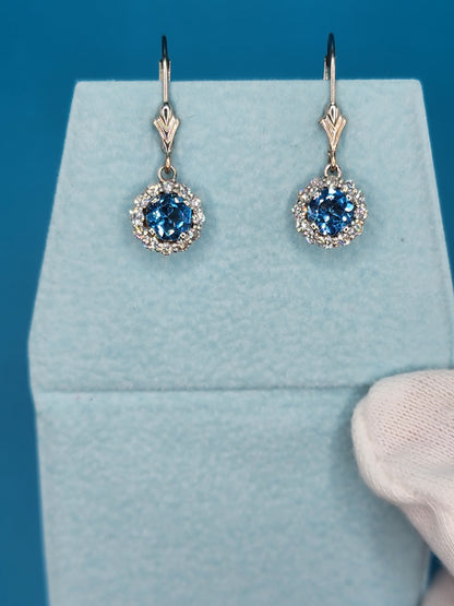 Blue Topaz and Halo Diamonds Dangling Earrings in 14k White Gold