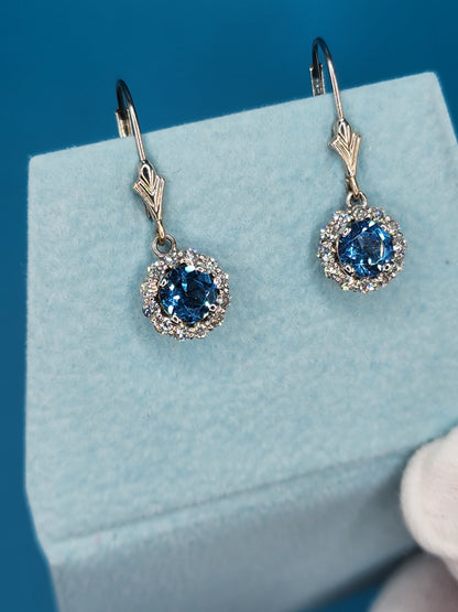 Blue Topaz and Halo Diamonds Dangling Earrings in 14k White Gold