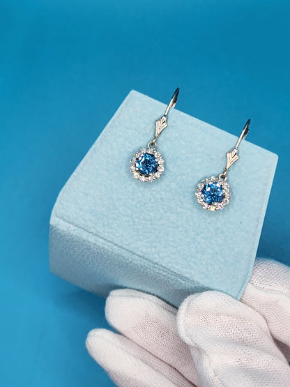 Blue Topaz and Halo Diamonds Dangling Earrings in 14k White Gold