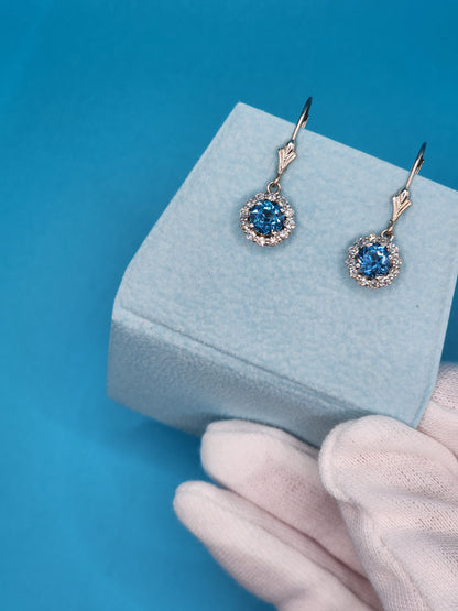 Blue Topaz and Halo Diamonds Dangling Earrings in 14k White Gold