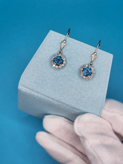 Blue Topaz and Halo Diamonds Dangling Earrings in 14k White Gold