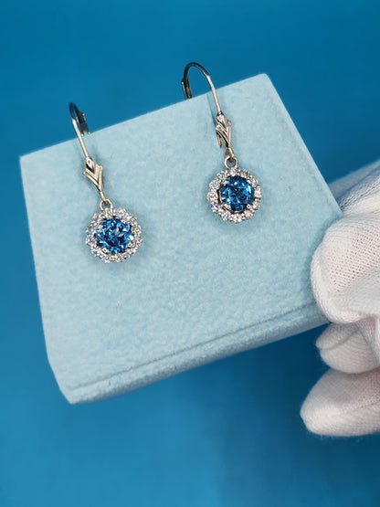 Blue Topaz and Halo Diamonds Dangling Earrings in 14k White Gold