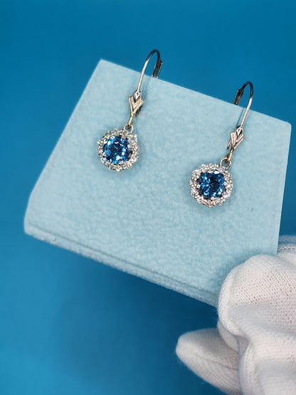 Blue Topaz and Halo Diamonds Dangling Earrings in 14k White Gold