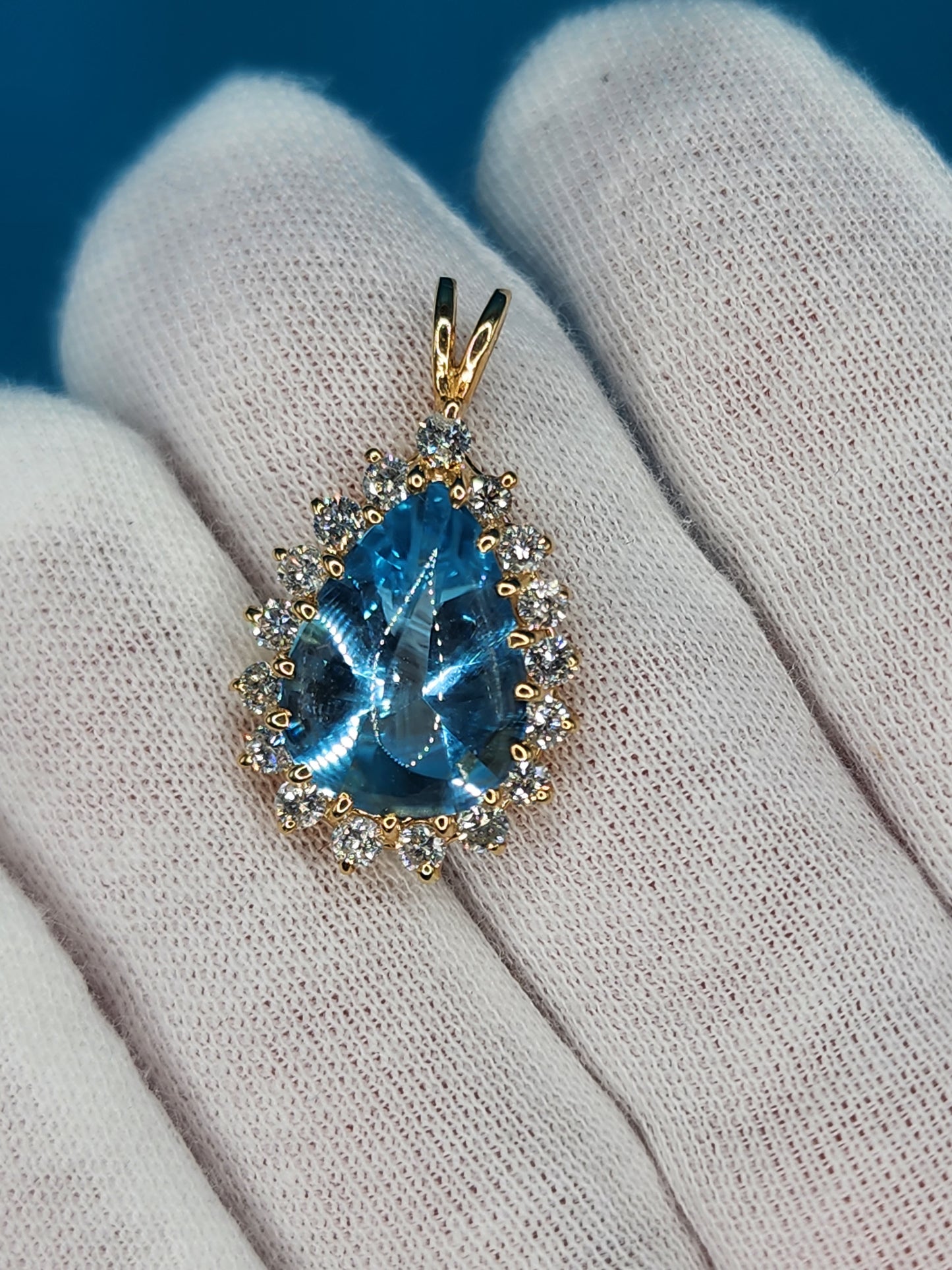 Buffed Top Pear Shape Blue Topaz and Halo Diamonds Pendant