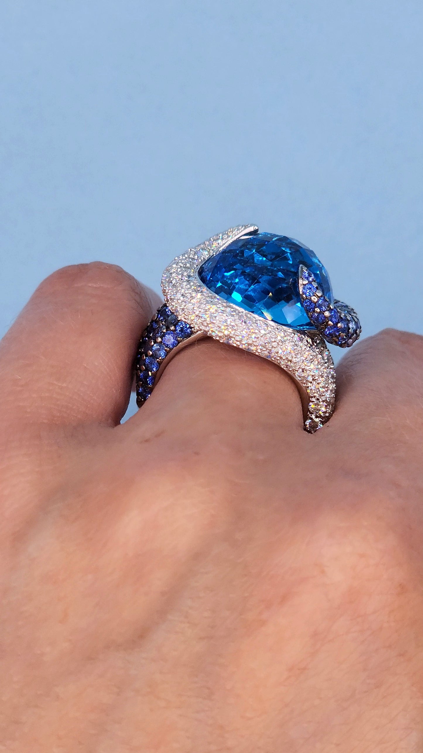 Large Cocktail Ring with Blue Topaz Center Accented by Diamond and Sapphire Swirl in 18k White Gold