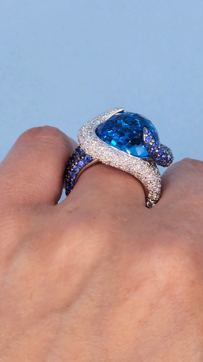 Large Cocktail Ring with Blue Topaz Center Accented by Diamond and Sapphire Swirl in 18k White Gold