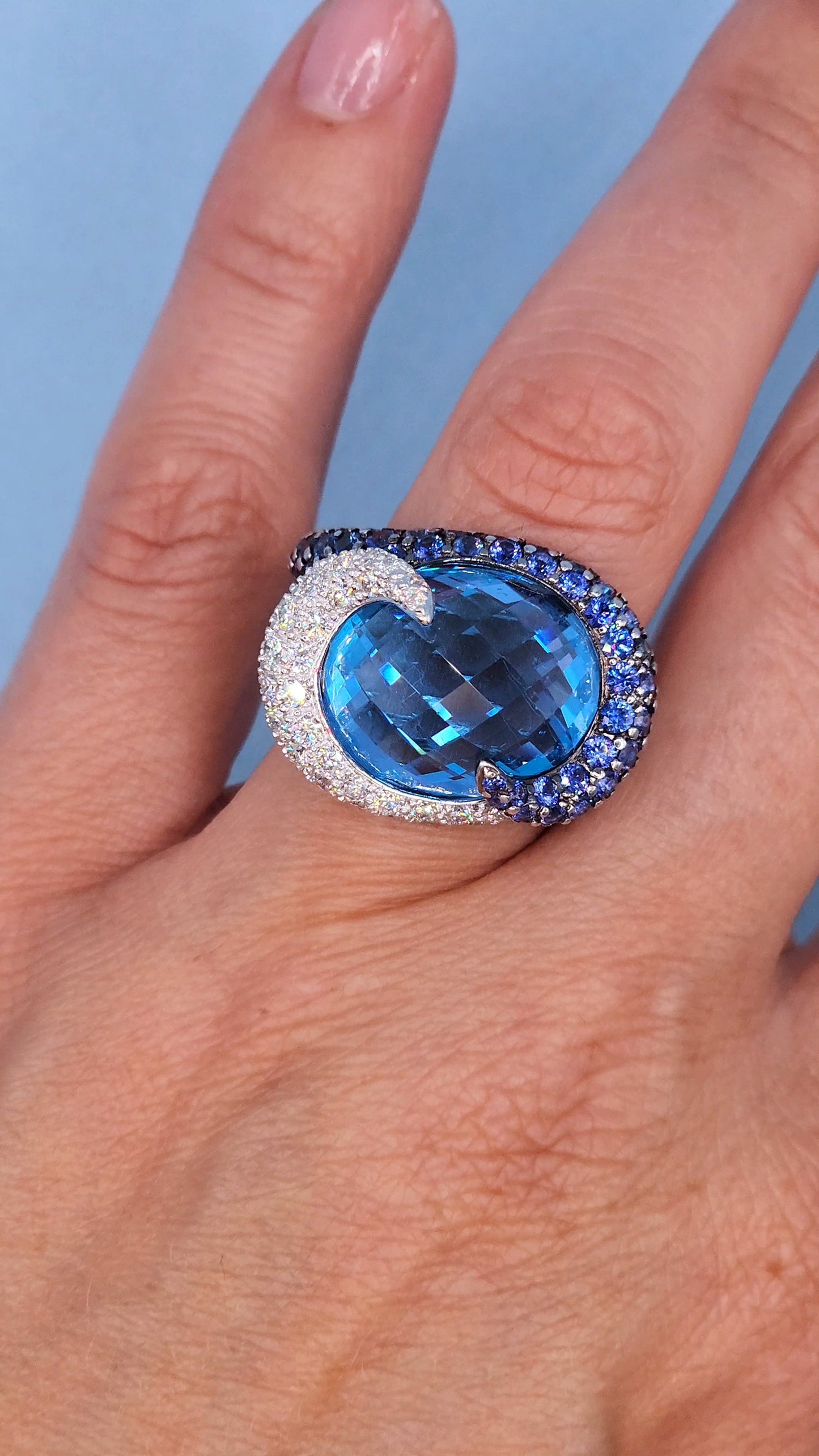 Large Cocktail Ring with Blue Topaz Center Accented by Diamond and Sapphire Swirl in 18k White Gold