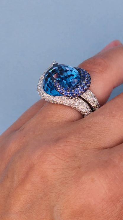 Large Cocktail Ring with Blue Topaz Center Accented by Diamond and Sapphire Swirl in 18k White Gold