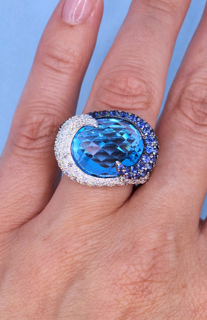 Large Cocktail Ring with Blue Topaz Center Accented by Diamond and Sapphire Swirl in 18k White Gold