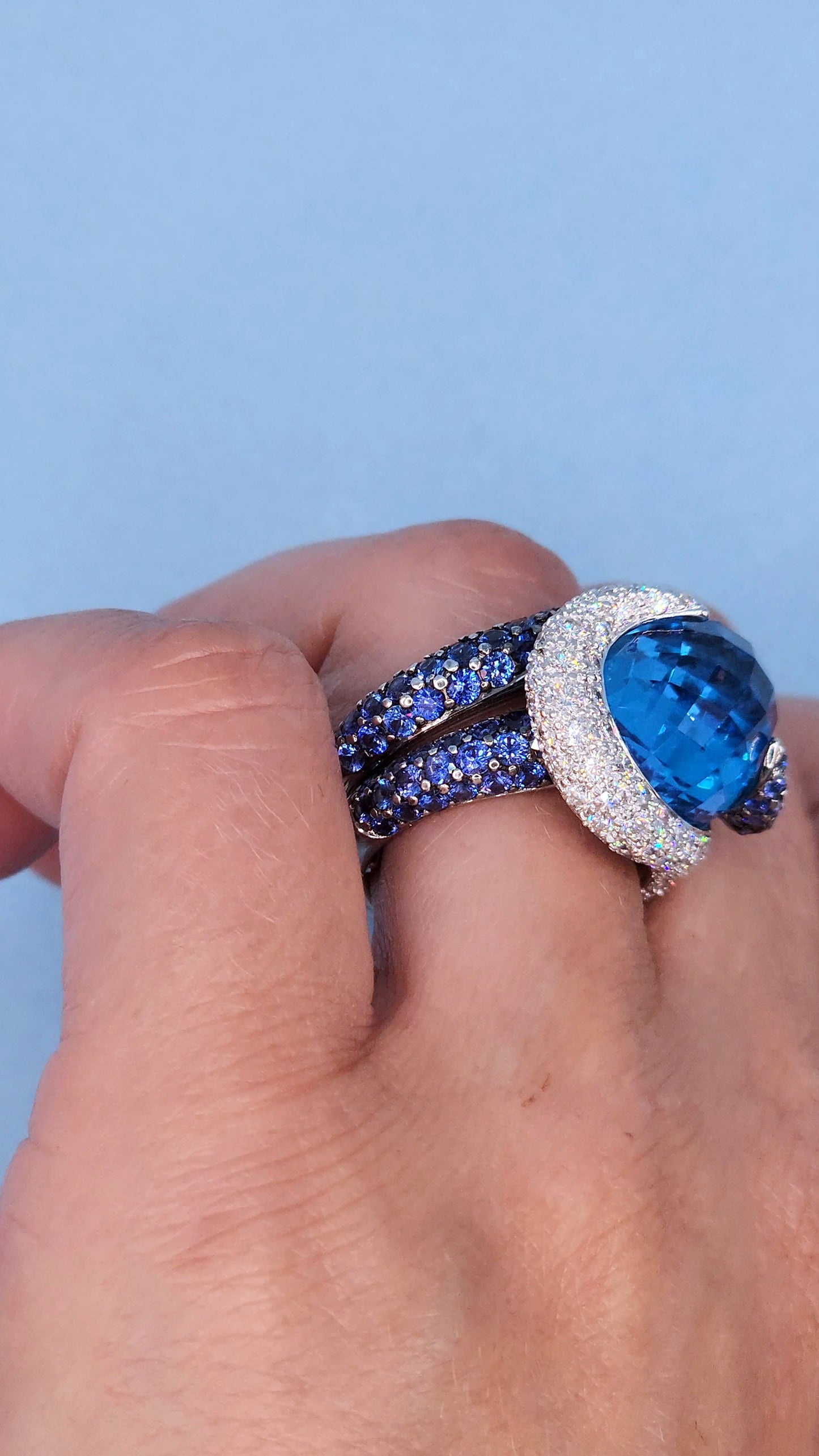 Large Cocktail Ring with Blue Topaz Center Accented by Diamond and Sapphire Swirl in 18k White Gold