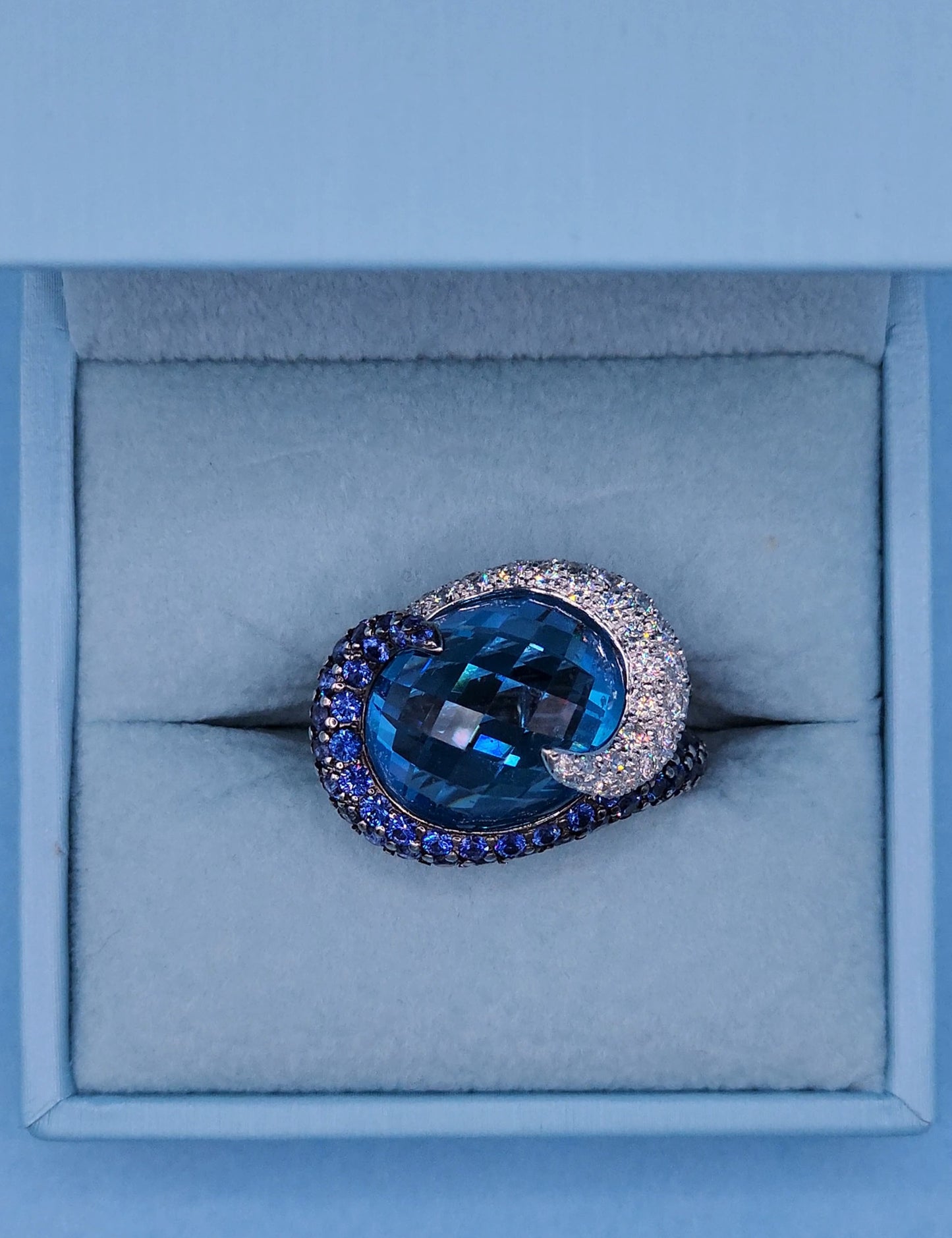 Large Cocktail Ring with Blue Topaz Center Accented by Diamond and Sapphire Swirl in 18k White Gold