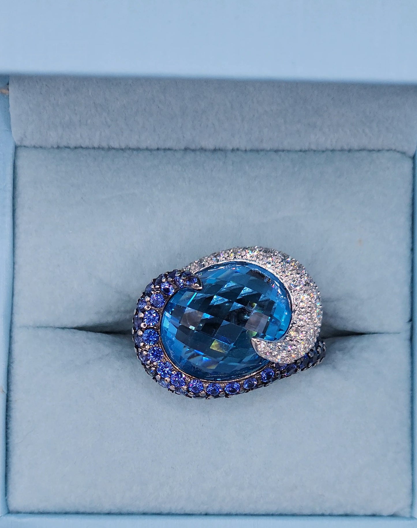 Large Cocktail Ring with Blue Topaz Center Accented by Diamond and Sapphire Swirl in 18k White Gold