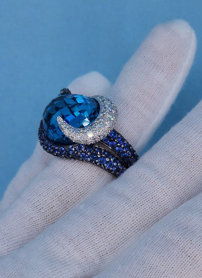 Large Cocktail Ring with Blue Topaz Center Accented by Diamond and Sapphire Swirl in 18k White Gold