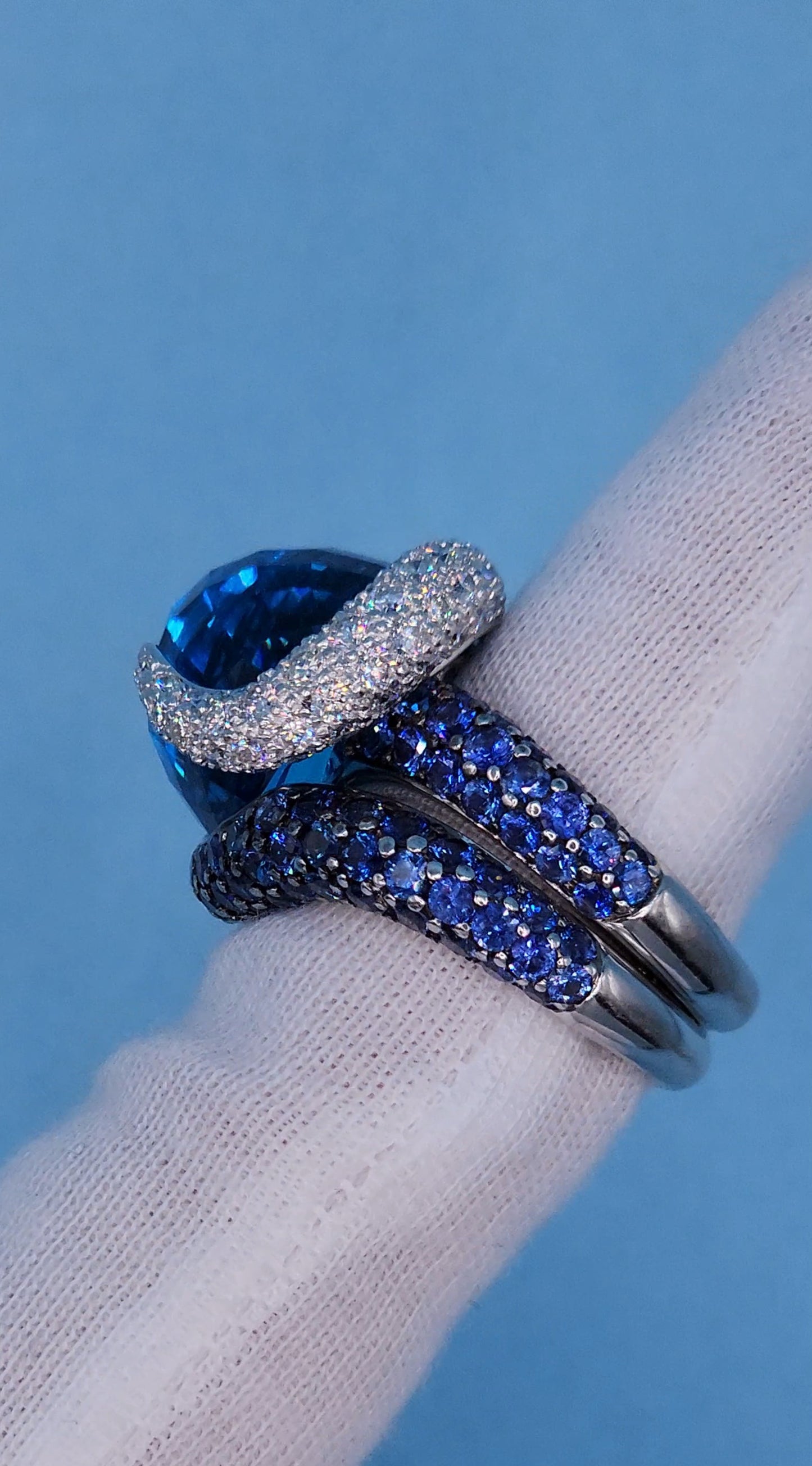 Large Cocktail Ring with Blue Topaz Center Accented by Diamond and Sapphire Swirl in 18k White Gold