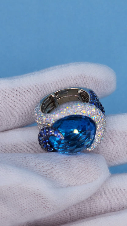 Large Cocktail Ring with Blue Topaz Center Accented by Diamond and Sapphire Swirl in 18k White Gold