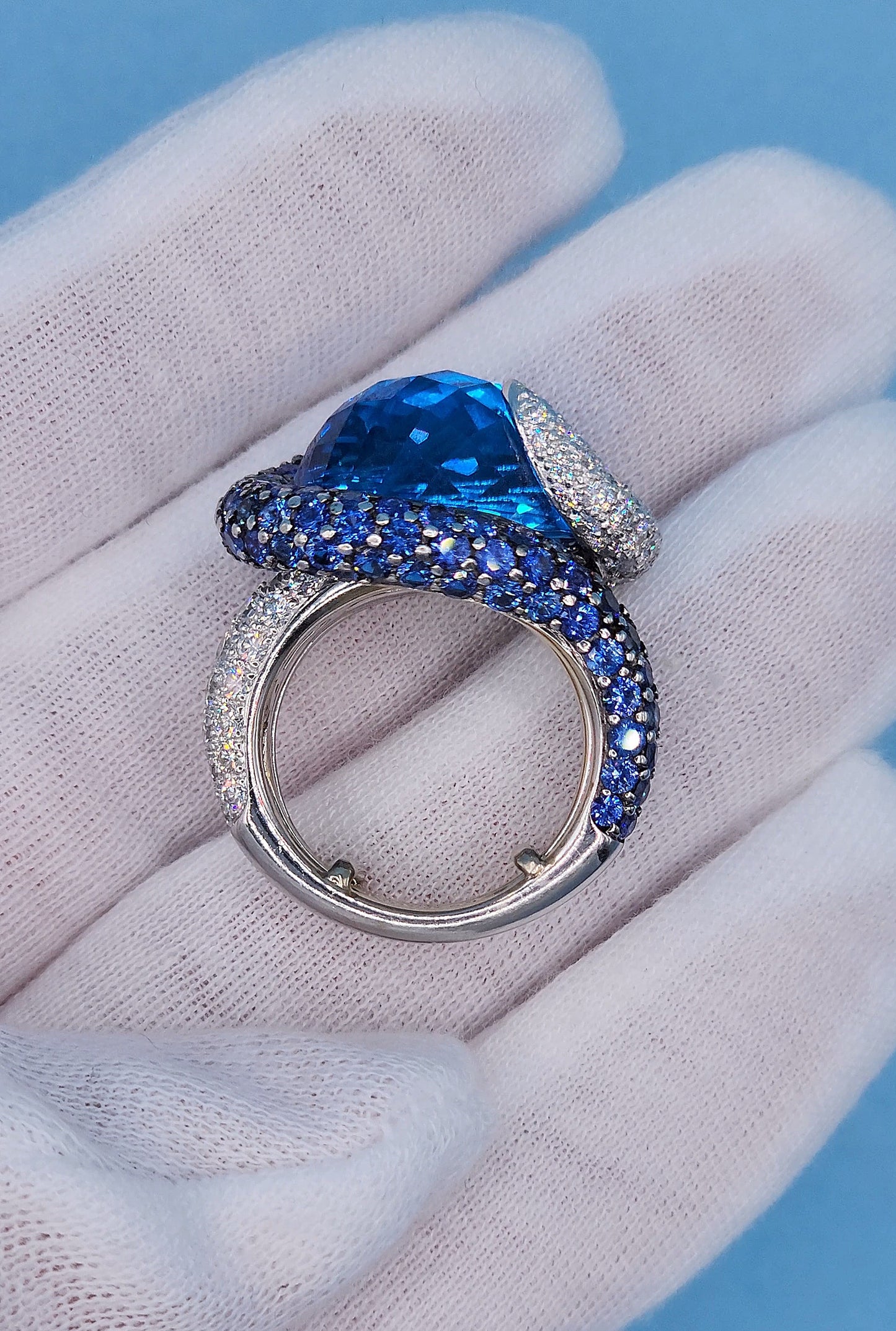 Large Cocktail Ring with Blue Topaz Center Accented by Diamond and Sapphire Swirl in 18k White Gold