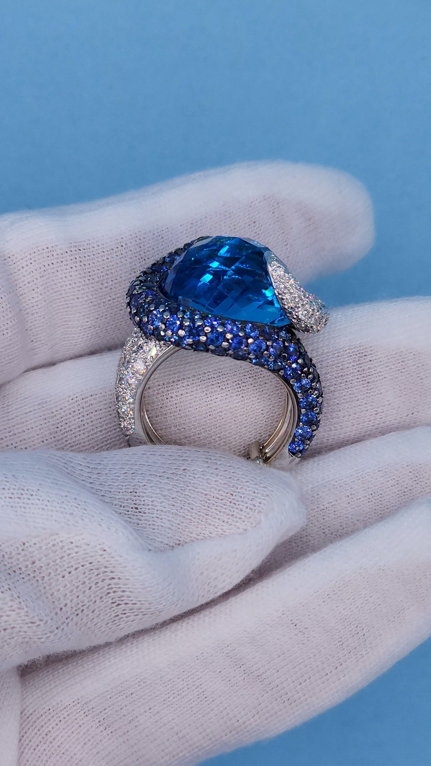 Large Cocktail Ring with Blue Topaz Center Accented by Diamond and Sapphire Swirl in 18k White Gold