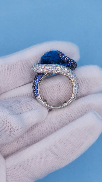 Large Cocktail Ring with Blue Topaz Center Accented by Diamond and Sapphire Swirl in 18k White Gold