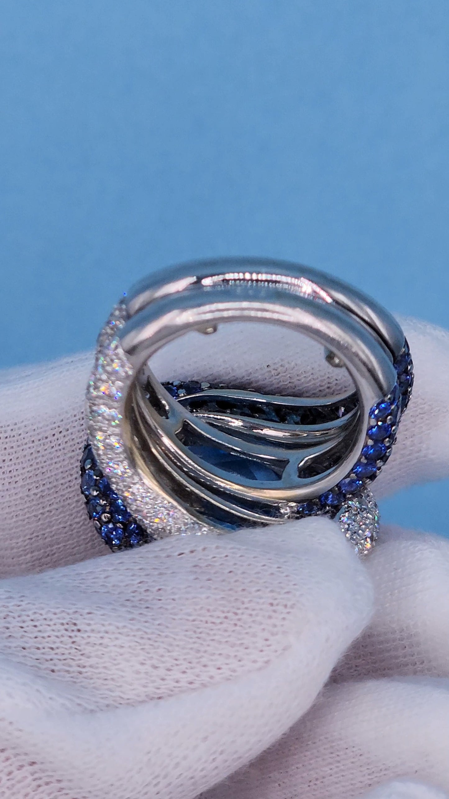 Large Cocktail Ring with Blue Topaz Center Accented by Diamond and Sapphire Swirl in 18k White Gold