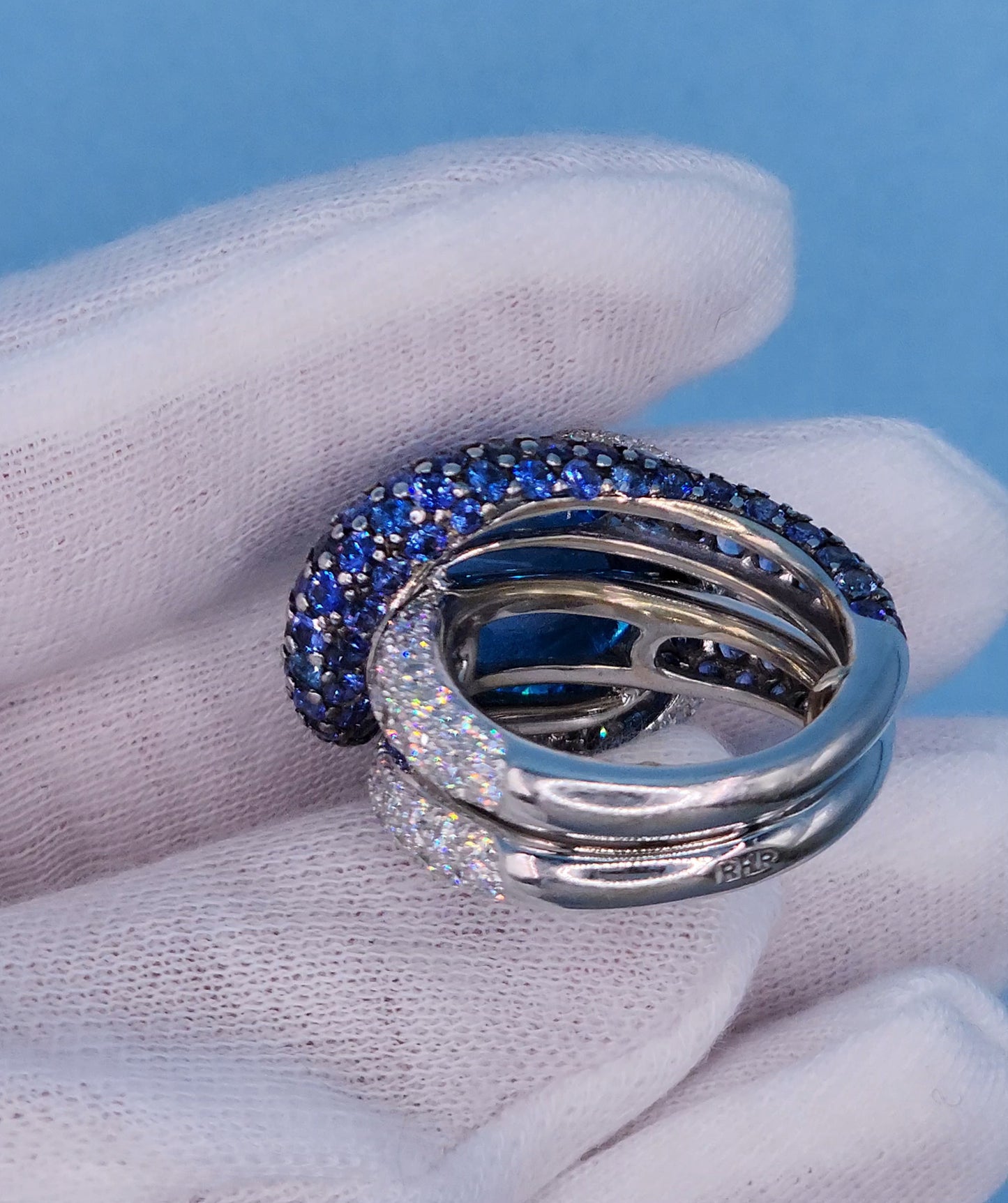 Large Cocktail Ring with Blue Topaz Center Accented by Diamond and Sapphire Swirl in 18k White Gold