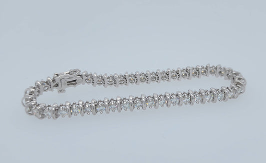 14k white gold moissanite tennis bracelet with bar-style setting, double safety clasp, 7.25 inches long, approx. 5 carat total weight, 5.7 mm wide, elegant and luxurious wristwear.