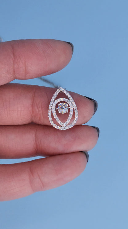 Close-up of double halo round diamond setting in teardrop pendant