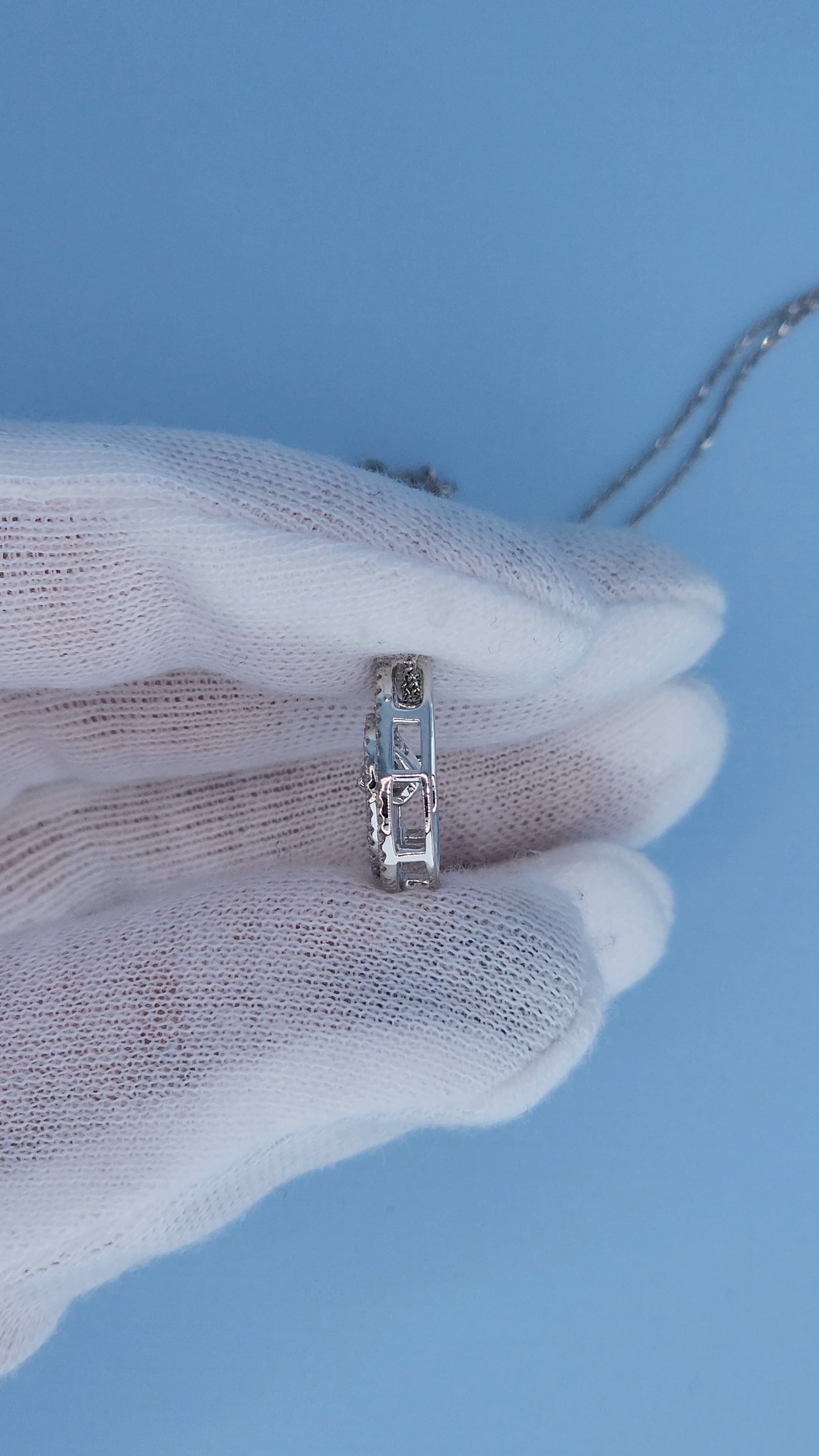 Side view of teardrop diamond pendant showing floating rose cut diamond movement design