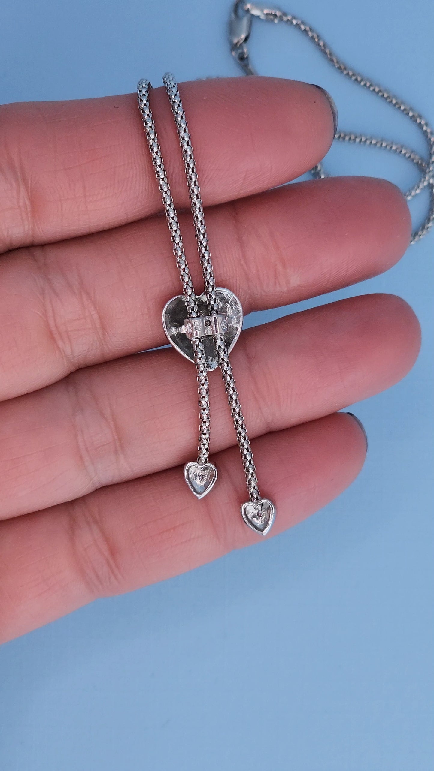 Close-up of heart-shaped lariat necklace showing the back