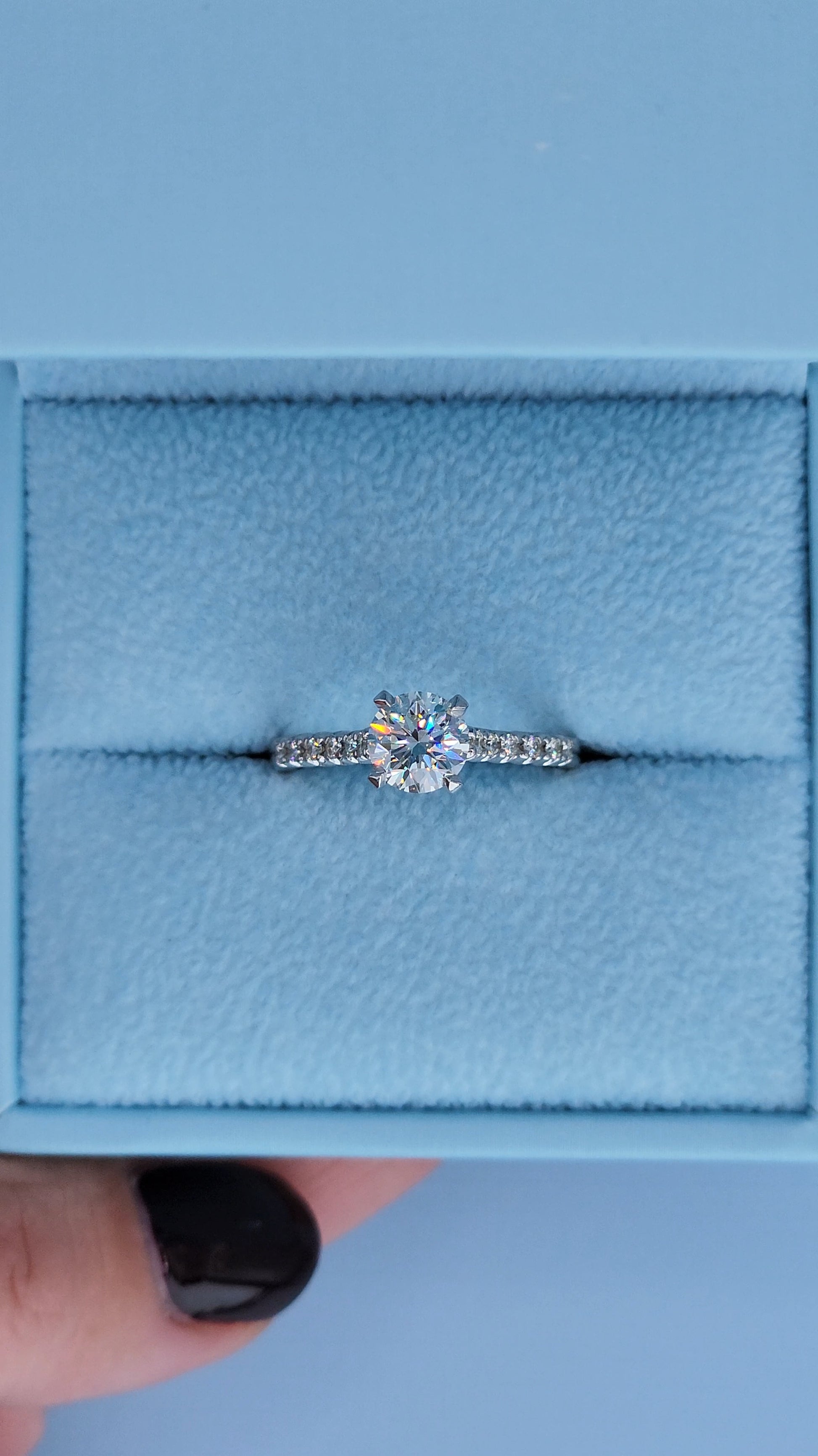 Close-up of four prong cathedral setting with round diamond center