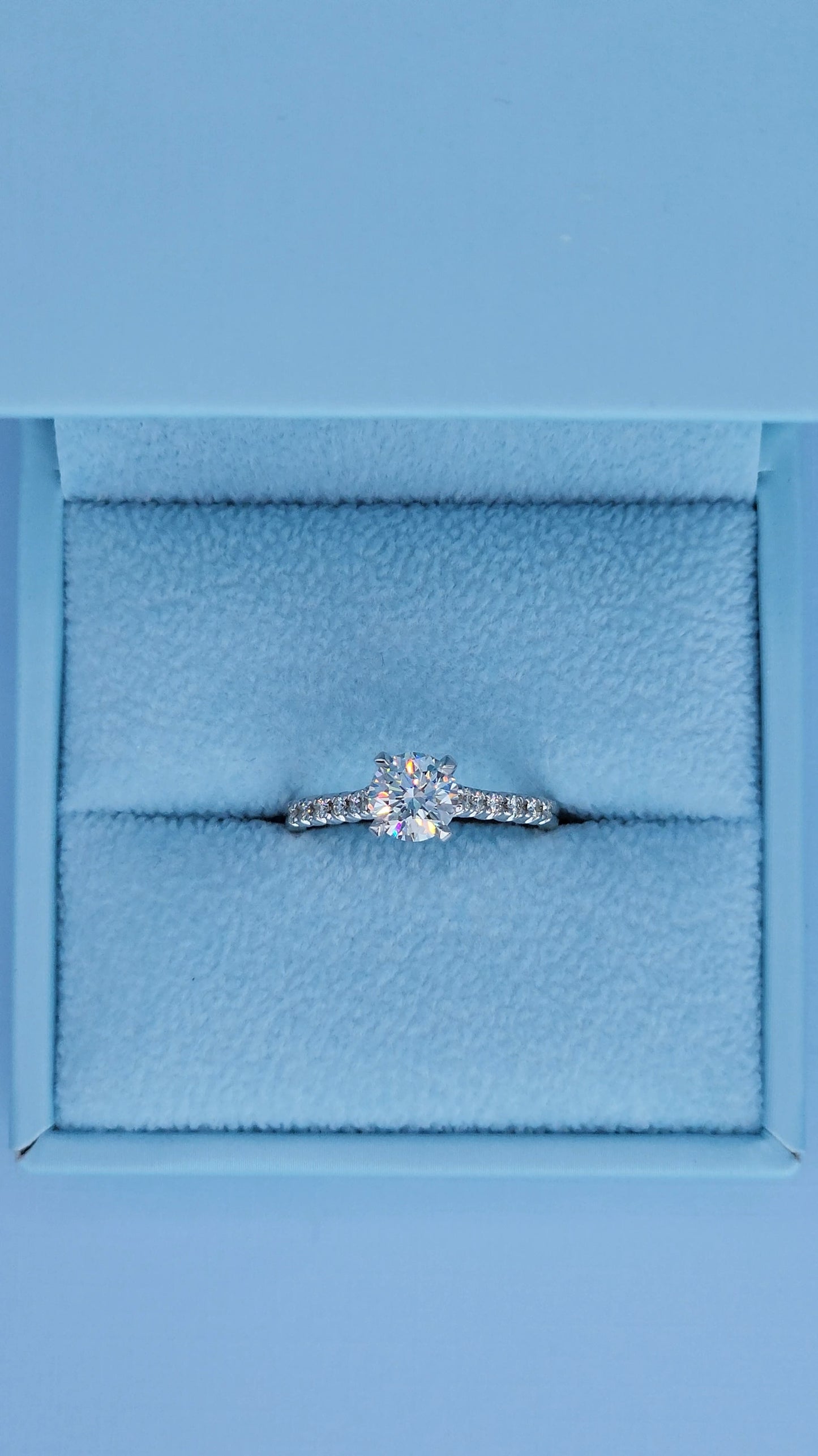 Diamond ring in a blue jewelry box