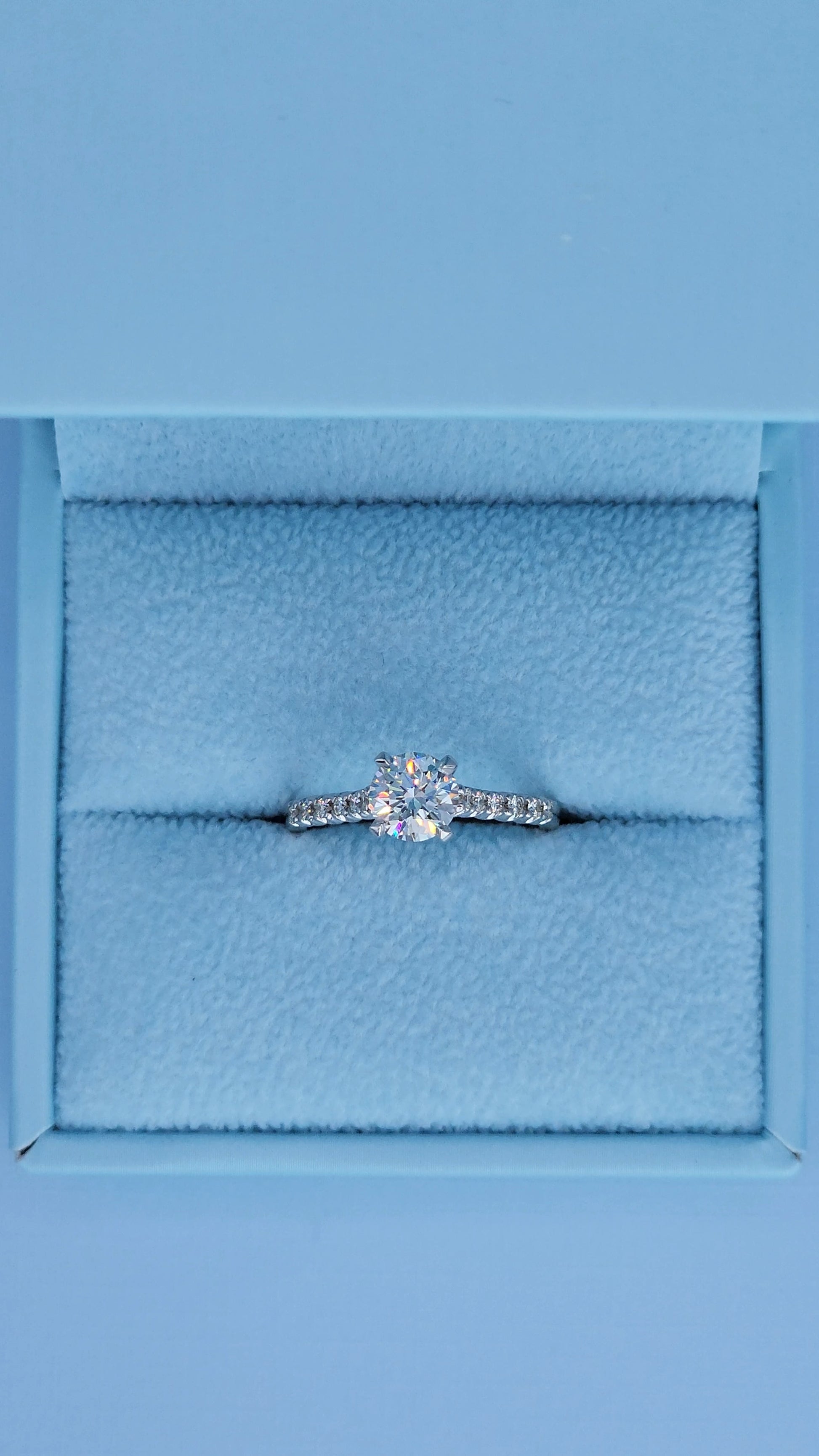 Diamond ring in a blue jewelry box