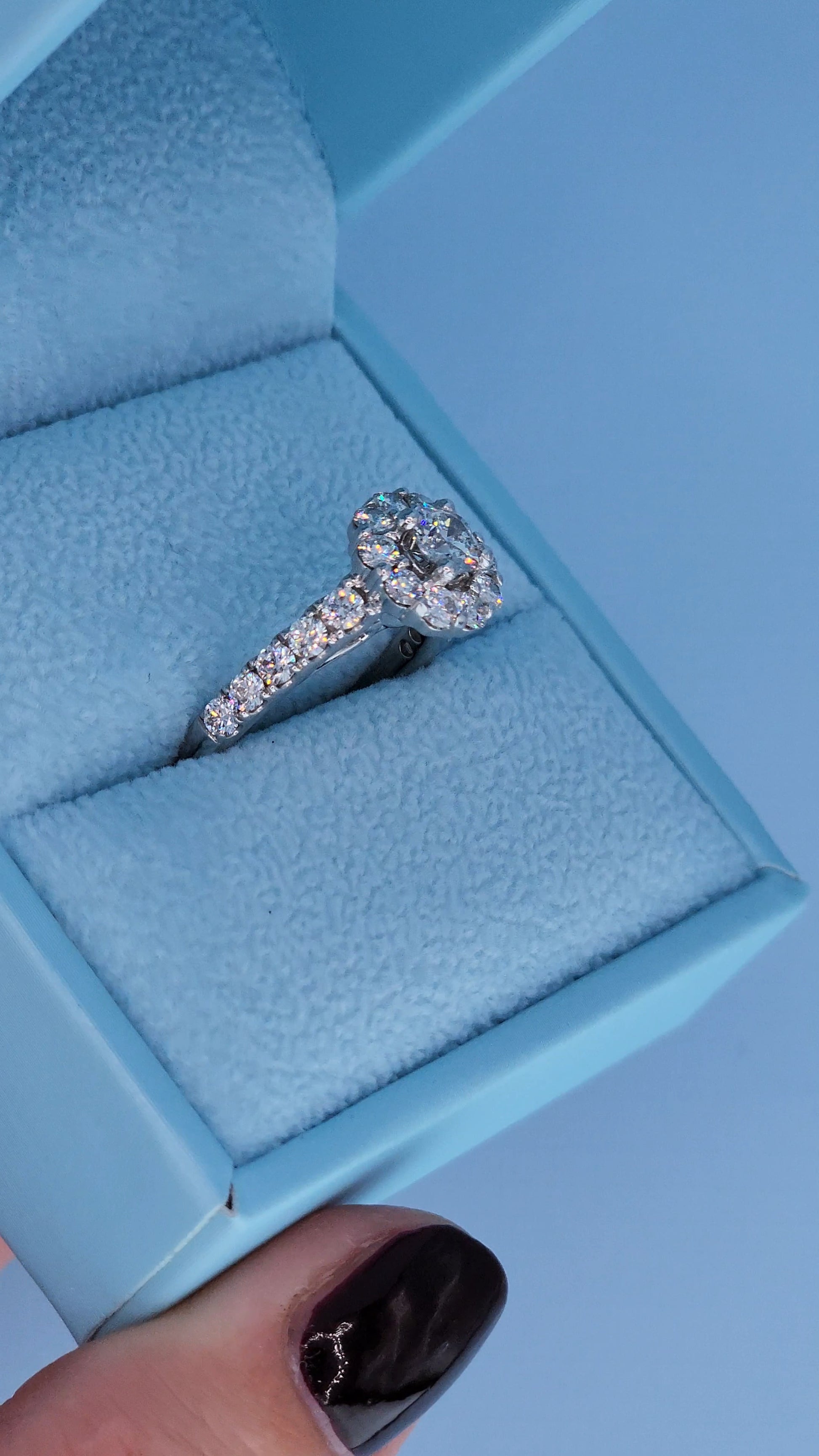 Diamond ring in a blue jewelry box, side view of the ring