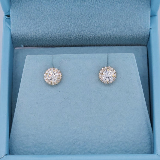 Close-up of 14k yellow gold halo diamond stud earrings featuring natural round cut diamonds, SI clarity, G-H color, with a secure push back setting and elegant sparkle.