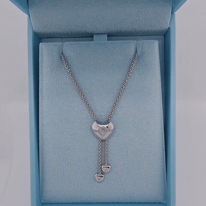 white gold necklace with heart pendants in a blue jewelry box