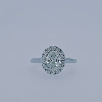 Close-up of a 1.00 carat oval diamond halo engagement ring in 14k white gold, featuring a plain polished shank and GSI-certified center diamond with sparkling halo.
