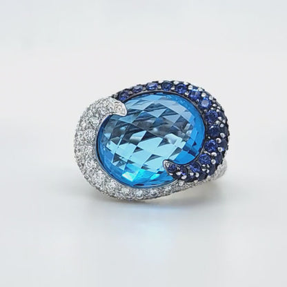 Large Cocktail Ring with Blue Topaz Center Accented by Diamond and Sapphire Swirl in 18k White Gold